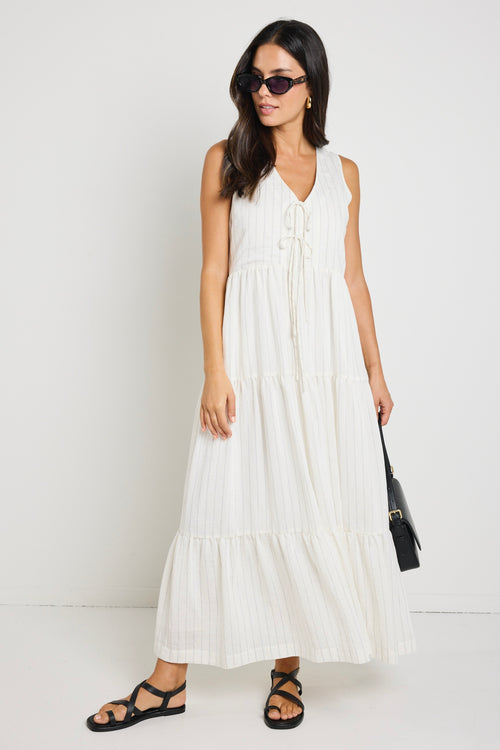 model wears a white stripe maxi dress