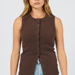Woman wearing a brown sleeveless top and blue jeans on a white background