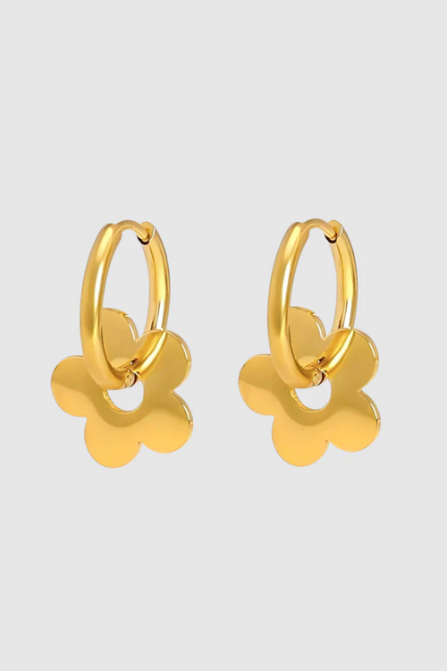 A pair of gold-toned hoop earrings featuring dangling flower-shaped charms with smooth, rounded petals and a high-shine finish