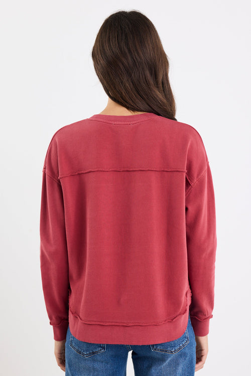 Person wearing a red sweatshirt and blue jeans on a white background
col_pattern