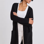 model wears a black cardigan