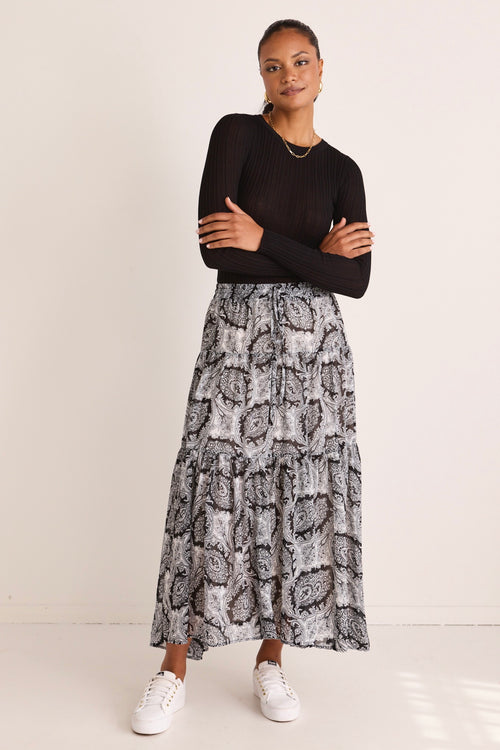model wears a black print maxi skirt