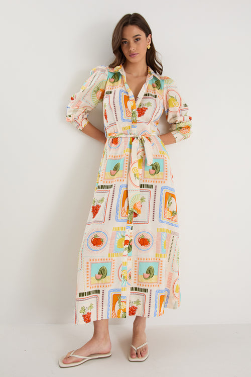Model wearing shirt dress with tropical postcard print