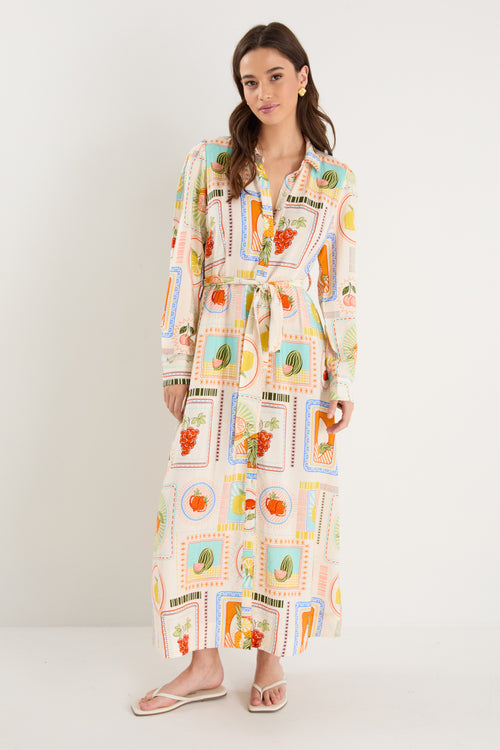 Model wearing shirt dress with tropical postcard print