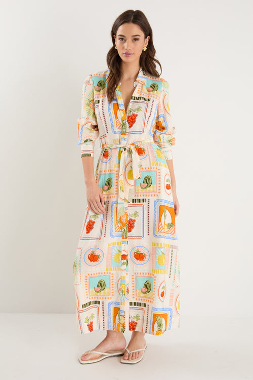 Model wearing shirt dress with tropical postcard print