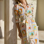 Model wearing shirt dress with tropical postcard print