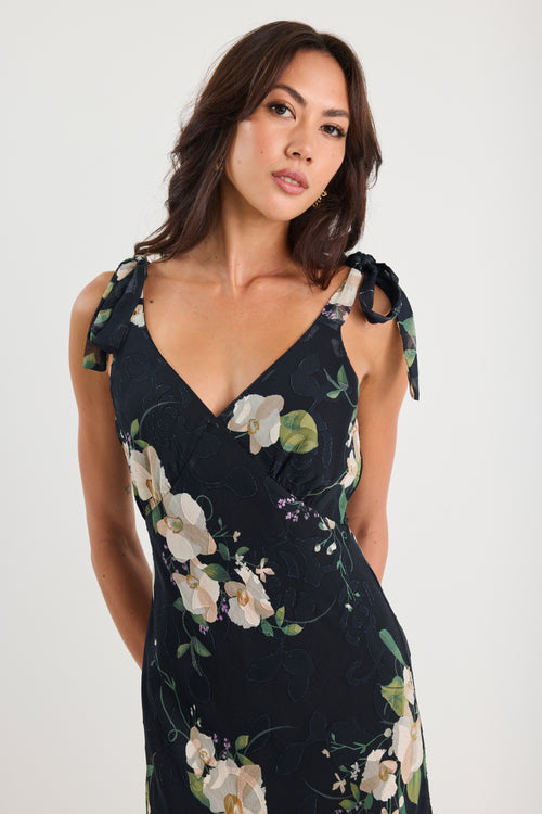 Woman wearing a floral dress against a white background