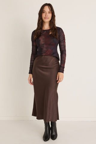 model wears a brown midi skirt