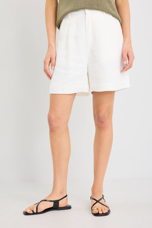 Person wearing white shorts on a plain background