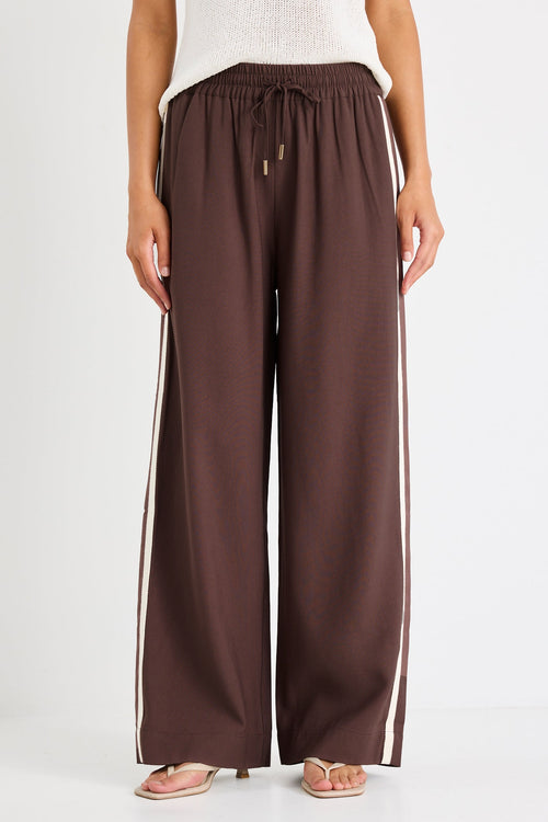 Brown wide-leg pants worn by a person on a white background