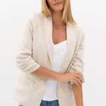 model wears a beige jacket