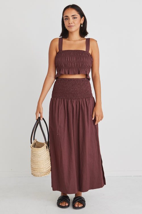 model wearing matching brown crop top and maxi skirt set