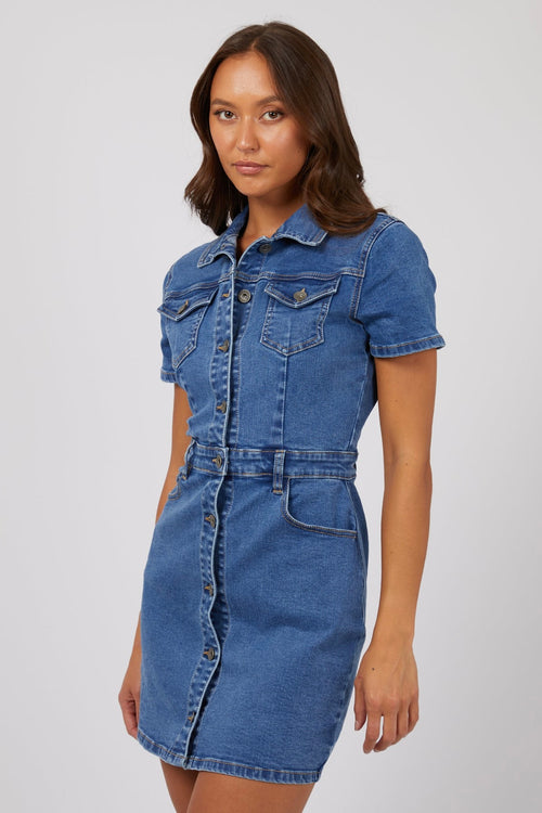 model wears a blue mini denim dress