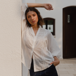 women wears a white blouse with dark blue denim skirt