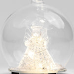 Decorative angel figure under a glass dome on a white background