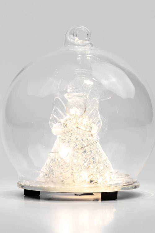 Decorative angel figure under a glass dome on a white background