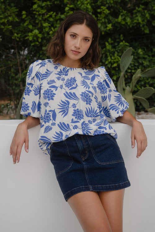 Woman wears a blue white floral blouse