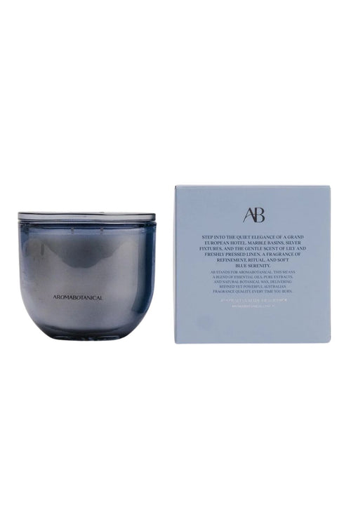 A blue glass jar candle next to its light blue packaging box, featuring the AB Clean Fragrances logo and product details, set against a plain white background.