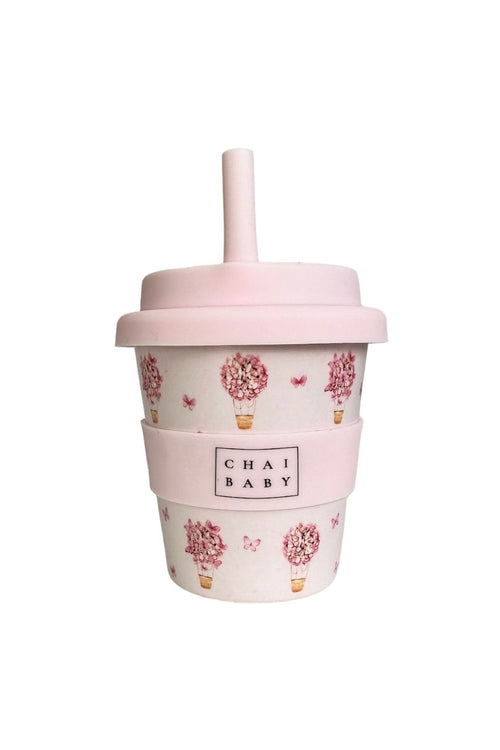 Pink tumbler with floral designs and 'Chai Baby' branding on a white background