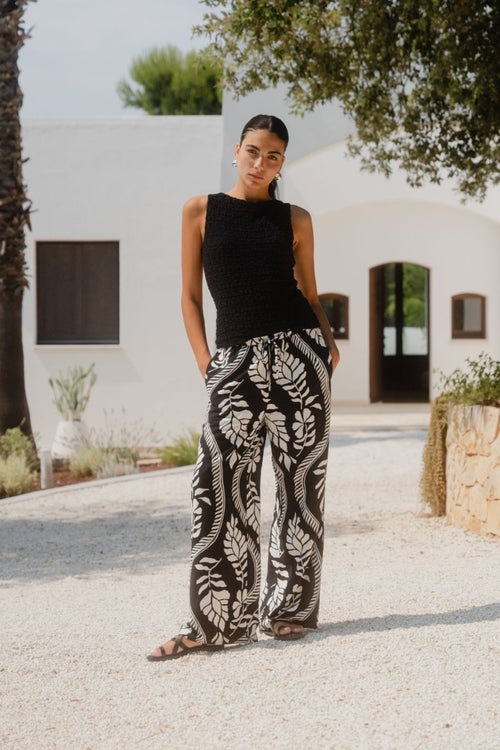 woman wearing black white pant and white top