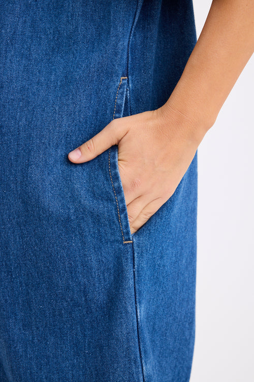 model wears a blue denim mini dress