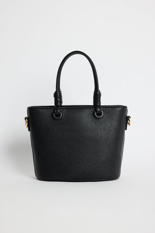 Small black PU leather handbag with knotted top handles and a long detachable shoulder strap, photographed against a plain light background