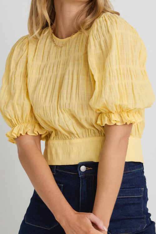 model wears a yellow puff sleeve top