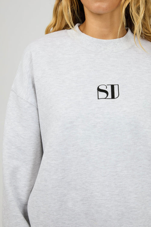 model wears a grey sweater