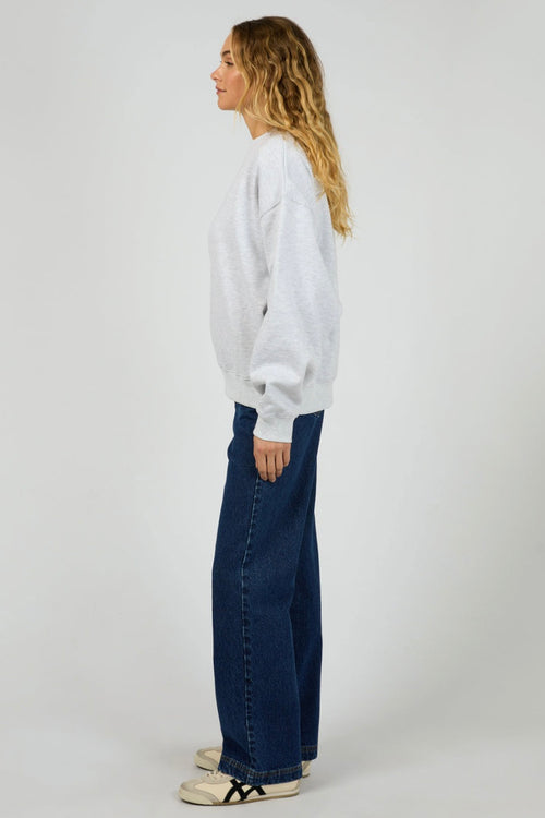 model wears a grey sweater