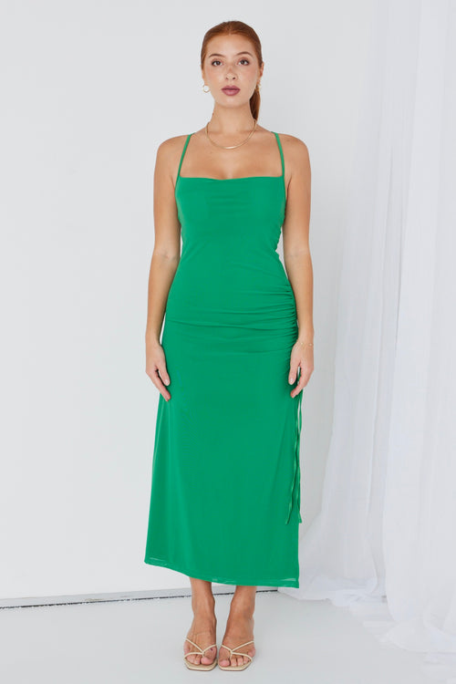 model wears a green maxi dress