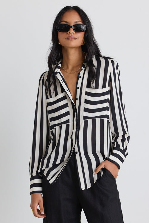 model wears a black white stripe shirt