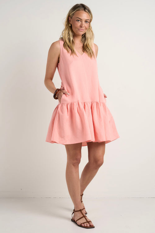 model wears a pink linen mini dress