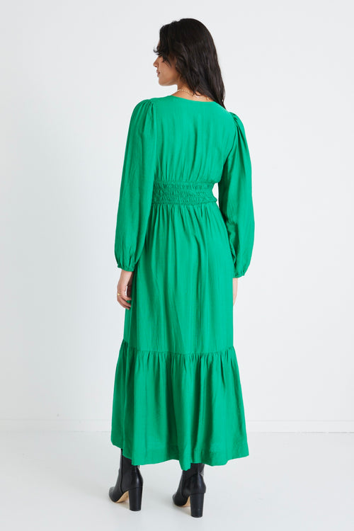 model wears a green dress