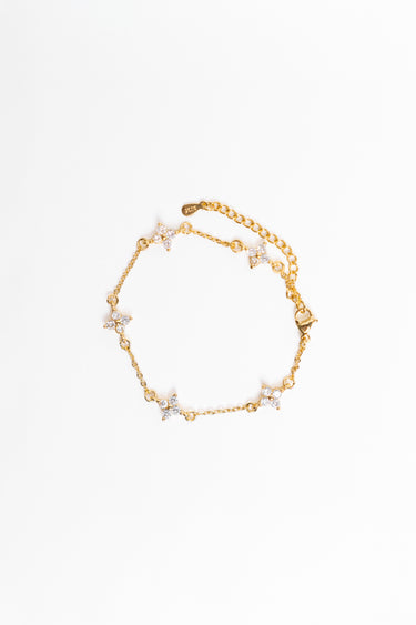 Gold bracelet with star-shaped charms on a white background