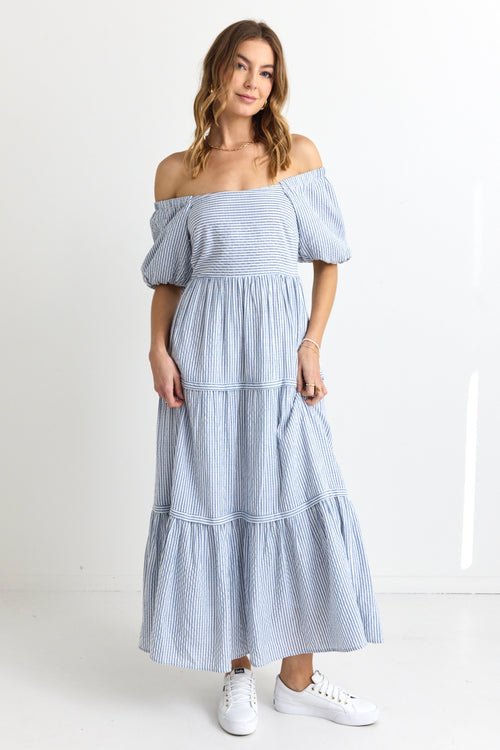  model wears a blue white stripe maxi dress