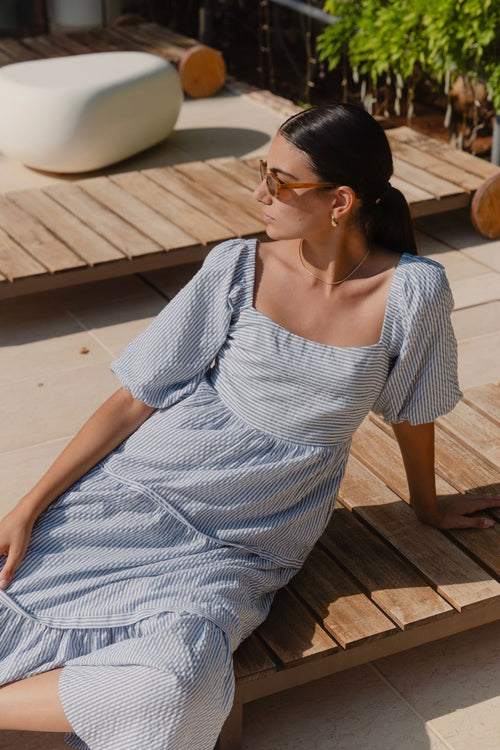 model wears a blue white stripe maxi dress