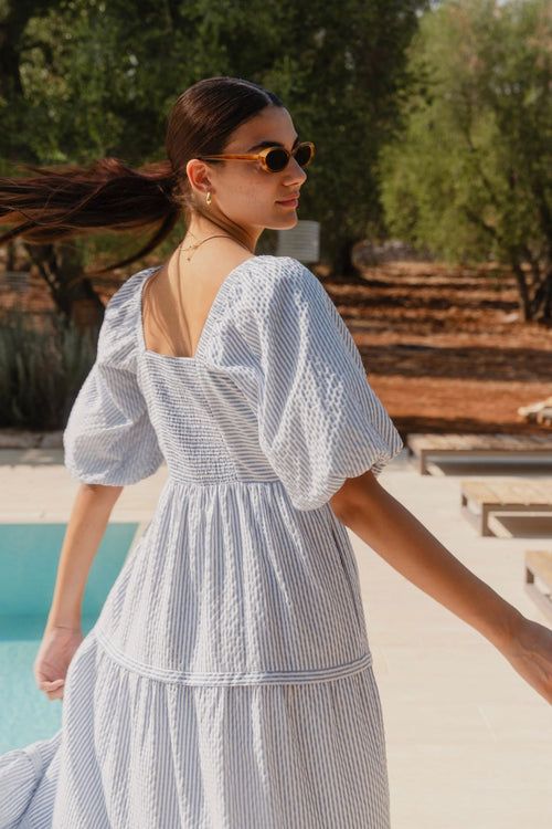 model wears a blue white stripe maxi dress