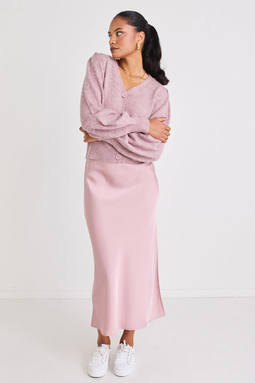 model wears a pink satin maxi skirt