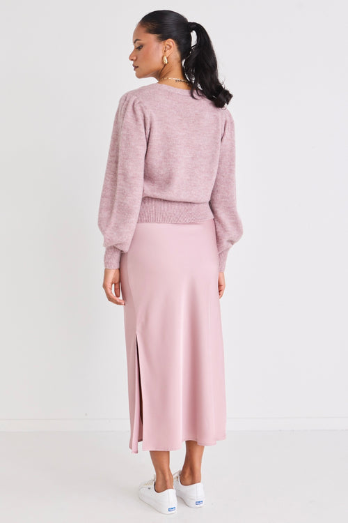 model wears a pink satin maxi skirt