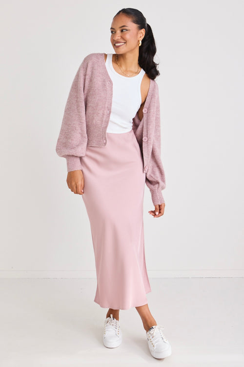 model wears a pink satin maxi skirt