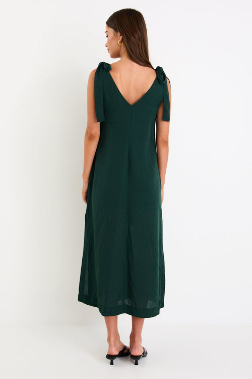Model wearing a forest-green tie-shoulder midi dress with a relaxed fit and flowy skirt