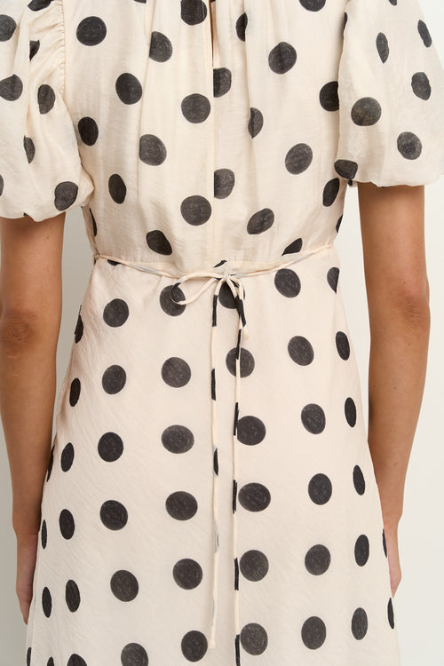 model wears a cream puff sleeve polka dot maxi dress
