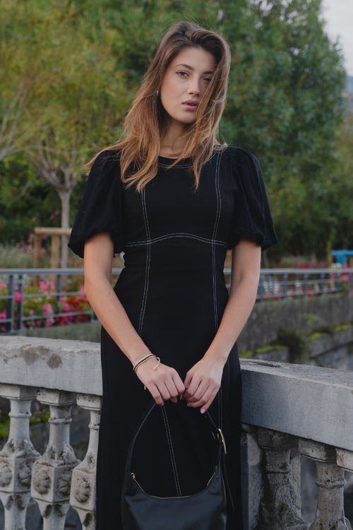 model wears black midi dress