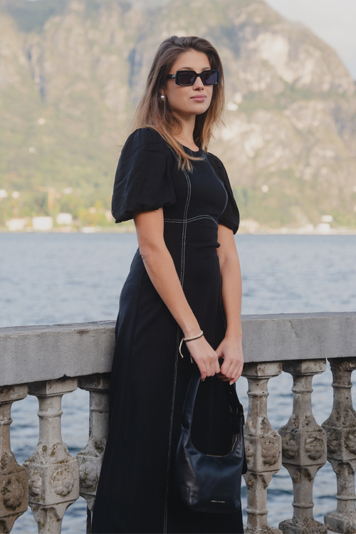 model wears black midi dress