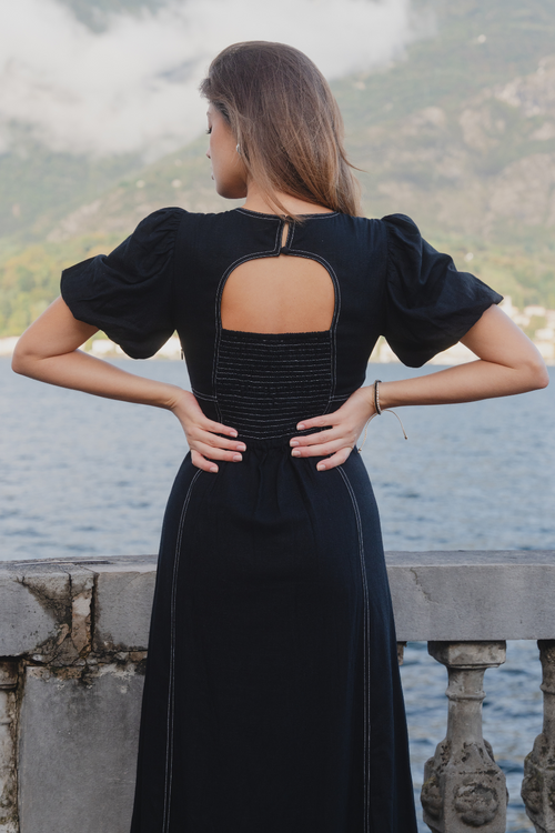 model wears black midi dress