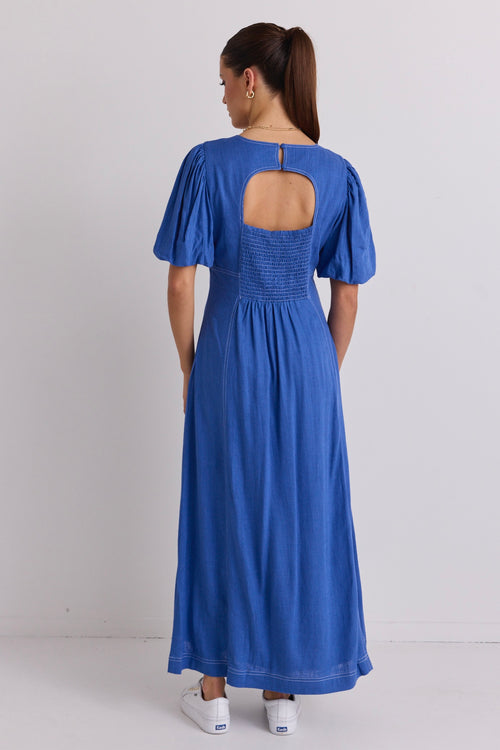 model wears a blue maxi dress