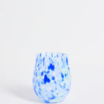 Blue and white speckled glass vase on a light gray background