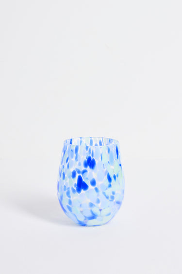 Blue and white speckled glass vase on a light gray background