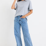 model wears a light blue high waisted wide leg jean