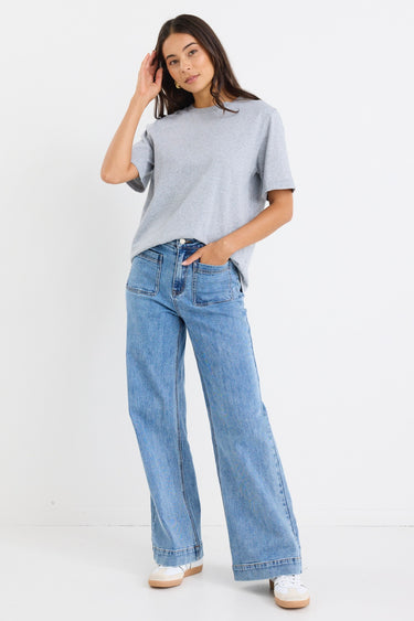 model wears a light blue high waisted wide leg jean